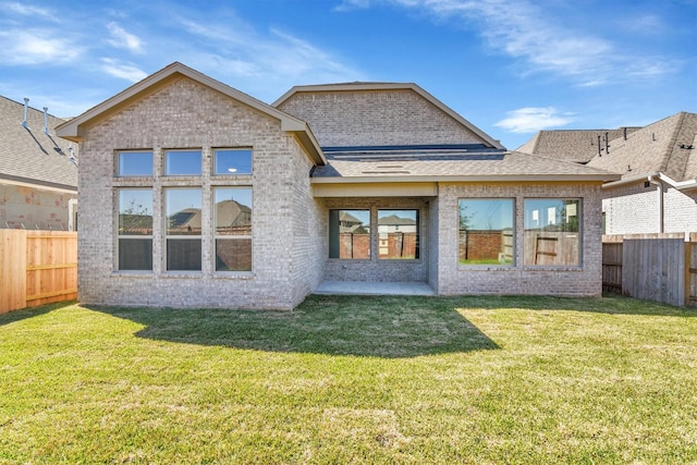 2920 Apple Rose, Katy, TX 77493 - rear view of property featuring brick siding, a fenced backyard, and a lawn