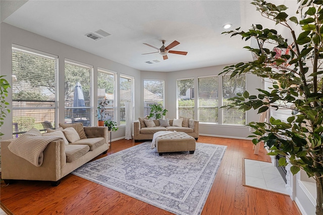 sunroom featuring visible vents and ceiling fan