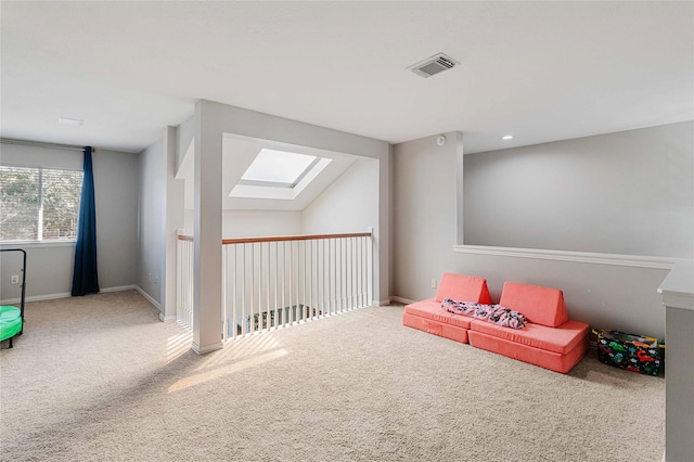 recreation room featuring carpet, a skylight, visible vents, and baseboards