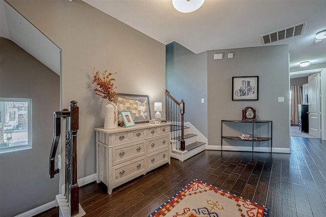 interior space featuring baseboards, stairs, visible vents, and dark wood-style flooring