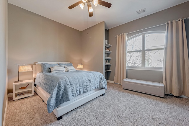 bedroom with carpet flooring, visible vents, and a ceiling fan