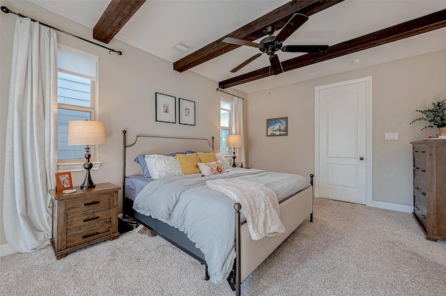 bedroom featuring beam ceiling, light colored carpet, visible vents, ceiling fan, and baseboards