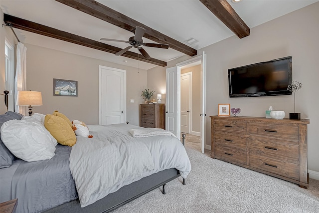 bedroom with light colored carpet, visible vents, ceiling fan, beamed ceiling, and baseboards