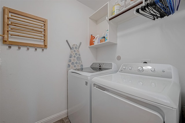 laundry room featuring laundry area, separate washer and dryer, and baseboards