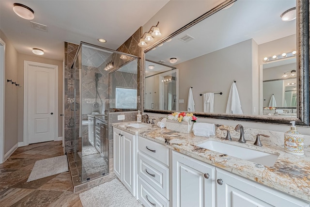 bathroom with double vanity, a sink, visible vents, and a shower stall