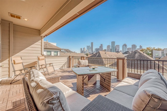 view of patio / terrace with a view of city, visible vents, and outdoor lounge area