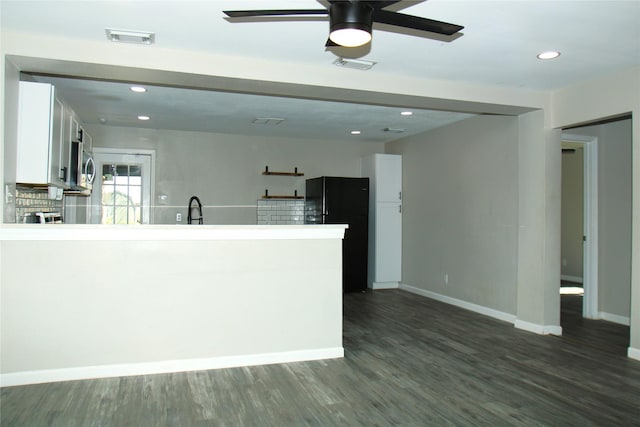 kitchen featuring dark wood-style floors, light countertops, visible vents, white cabinets, and a sink