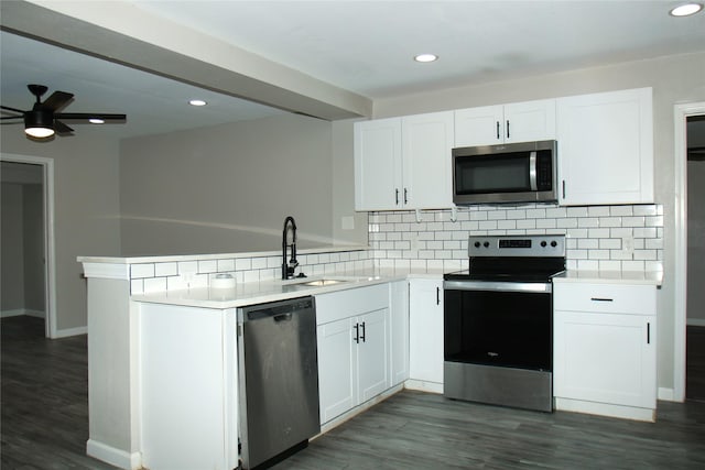 817 S Morgan St, Angleton, TX 77515 - kitchen featuring appliances with stainless steel finishes, a peninsula, backsplash, white cabinets, and recessed lighting