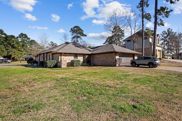 view of home's exterior with brick siding and a yard