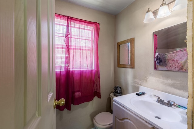 bathroom with toilet and vanity