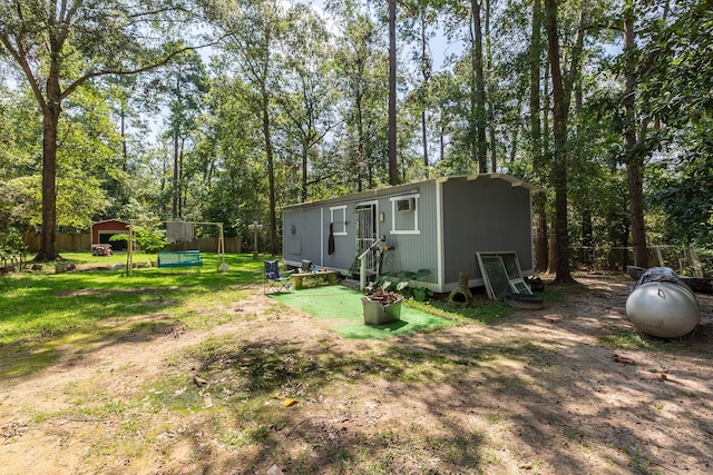 view of yard featuring an outdoor structure and fence