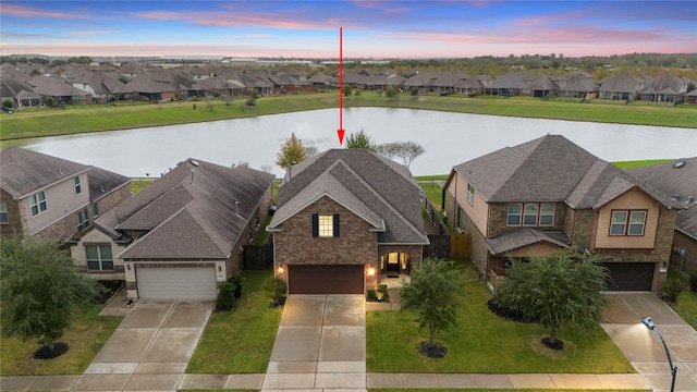 drone / aerial view with a residential view and a water view