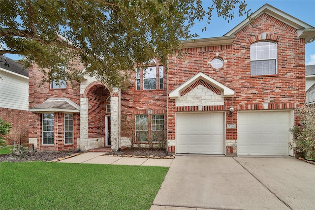 view of front of home featuring brick siding, an attached garage, a front yard, stone siding, and driveway