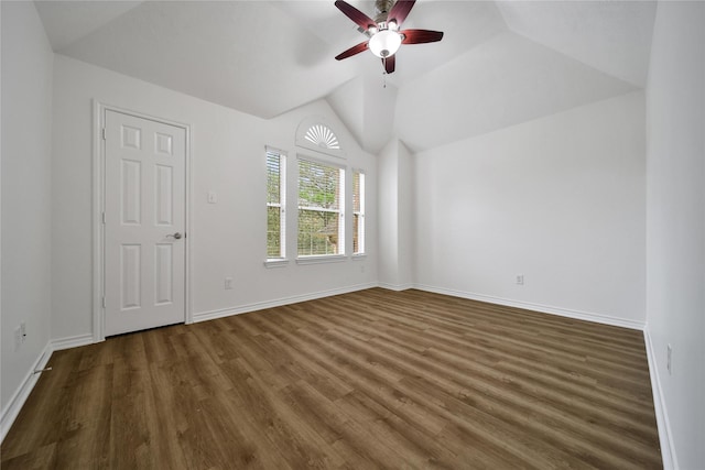 spare room featuring lofted ceiling, ceiling fan, baseboards, and dark wood finished floors