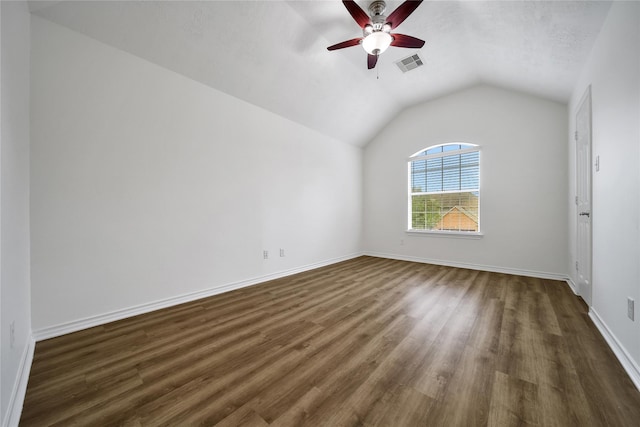 bonus room featuring ceiling fan, dark wood-style flooring, visible vents, baseboards, and vaulted ceiling