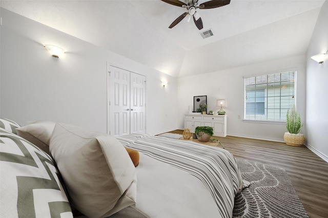 bedroom with visible vents, ceiling fan, vaulted ceiling, wood finished floors, and baseboards