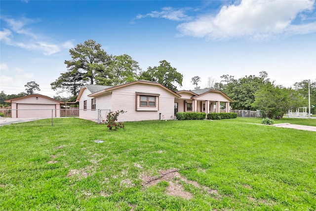 128 Legend Ln, Livingston, TX 77351 - ranch-style home featuring a garage, fence, an outdoor structure, and a front lawn