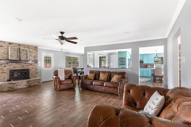 128 Legend Ln, Livingston, TX 77351 - living area featuring ceiling fan, crown molding, a brick fireplace, dark wood-style floors, and recessed lighting