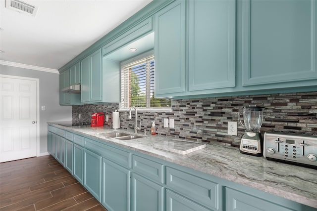 128 Legend Ln, Livingston, TX 77351 - kitchen featuring a sink, dark wood finished floors, tasteful backsplash, visible vents, and ornamental molding