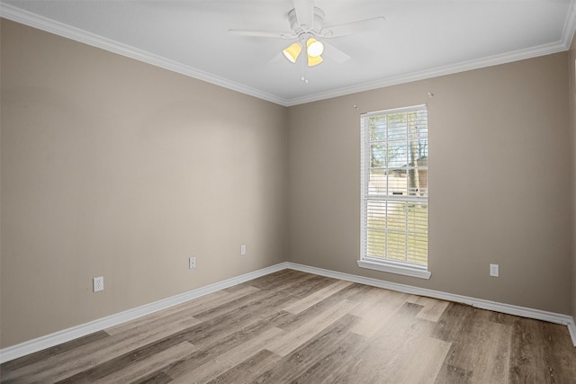 unfurnished room with light wood-style flooring, ornamental molding, ceiling fan, and baseboards