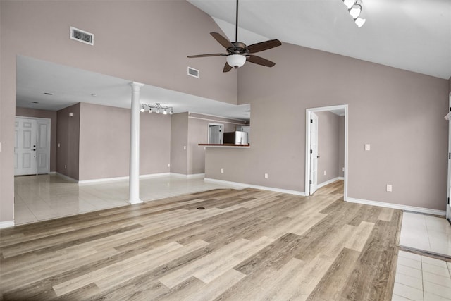 unfurnished living room featuring light wood-style flooring, decorative columns, visible vents, and a ceiling fan