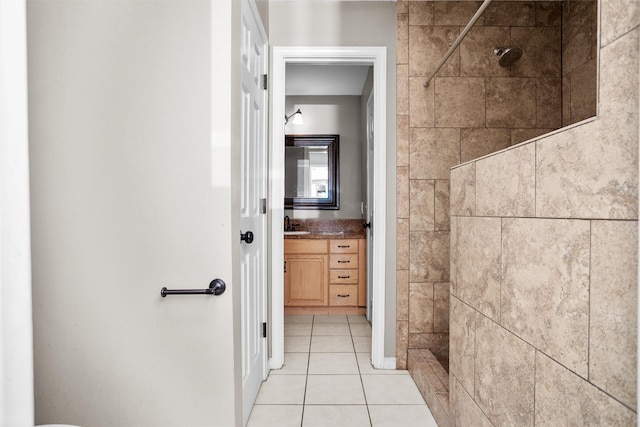 bathroom featuring tile patterned flooring, a shower stall, and vanity