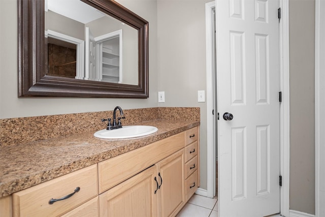 bathroom featuring tile patterned flooring and vanity