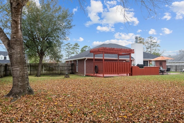 view of yard featuring a fenced backyard, a wooden deck, and a pergola