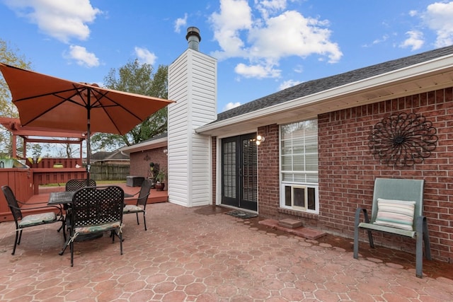 view of patio with fence and outdoor dining area