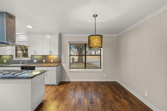 kitchen featuring island exhaust hood, hanging light fixtures, backsplash, white cabinetry, and dark stone countertops