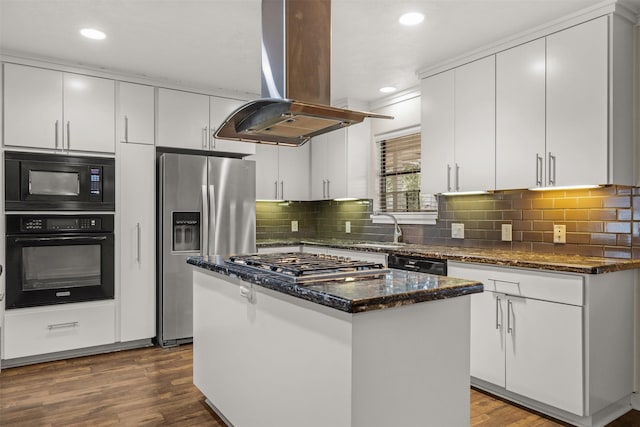 kitchen with wood finished floors, a kitchen island, white cabinetry, black appliances, and island exhaust hood