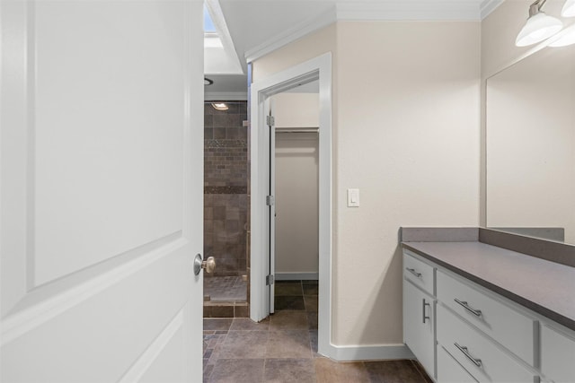 full bathroom featuring a shower stall, ornamental molding, a walk in closet, and vanity