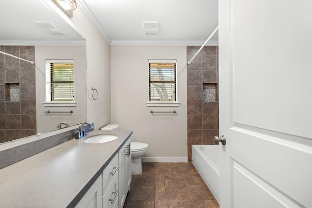 full bath featuring ornamental molding, stone finish floor, plenty of natural light, and vanity