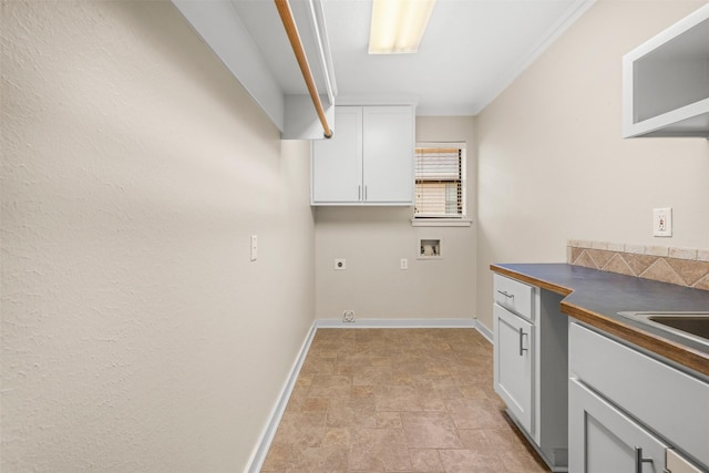 laundry area featuring washer hookup, cabinet space, stone finish floor, electric dryer hookup, and baseboards