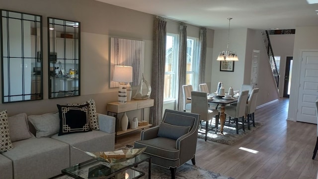 living area with a chandelier and wood finished floors