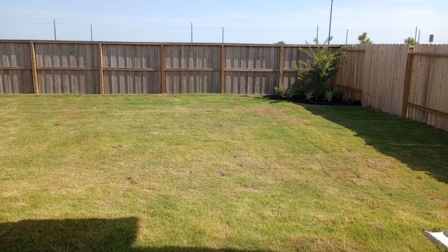 view of yard with a fenced backyard