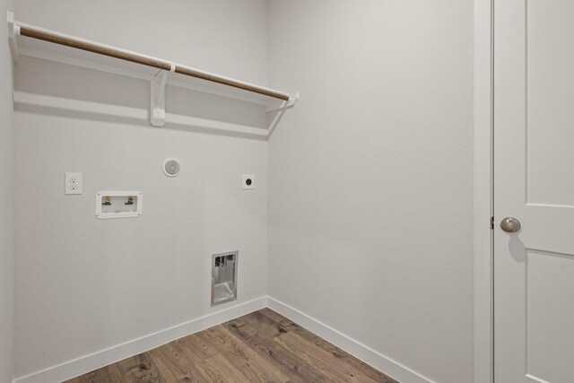 laundry room with electric dryer hookup, laundry area, baseboards, hookup for a washing machine, and dark wood-style flooring