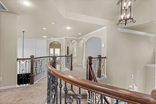 hall featuring light carpet, visible vents, an upstairs landing, and crown molding