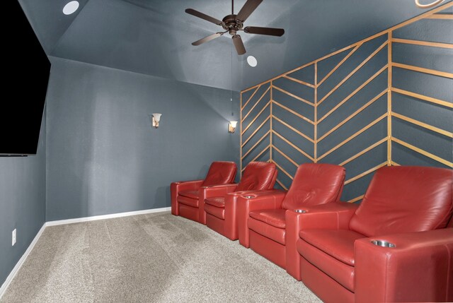 carpeted cinema featuring vaulted ceiling, a ceiling fan, and baseboards