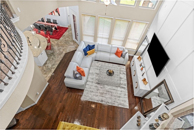 living area featuring dark wood-style floors and stairs