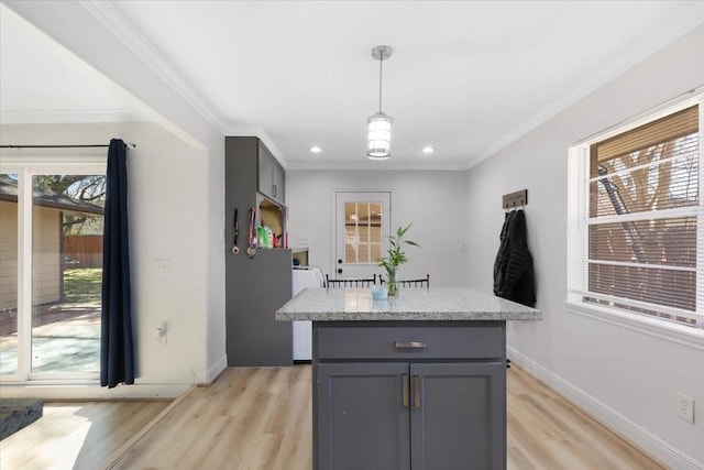 kitchen with light wood-type flooring, gray cabinets, and crown molding