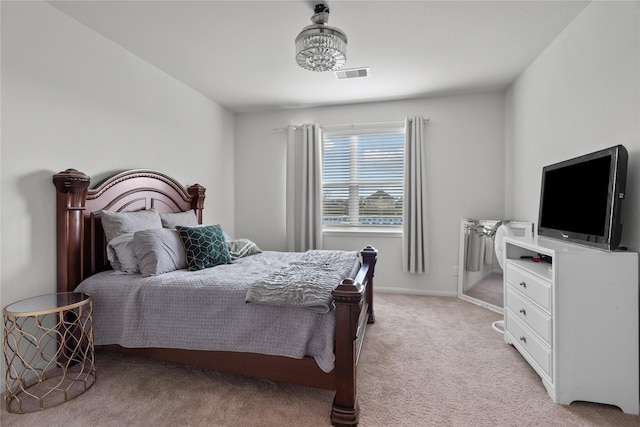 bedroom with light carpet, visible vents, and baseboards