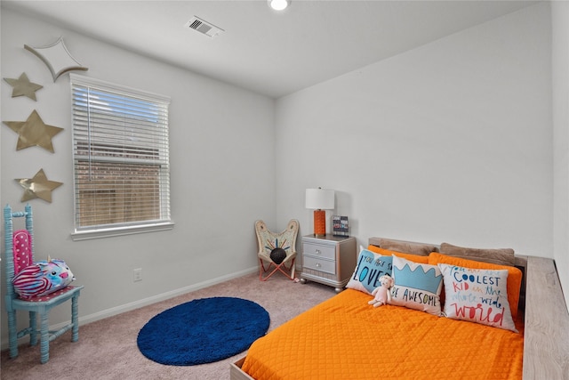 carpeted bedroom with visible vents and baseboards