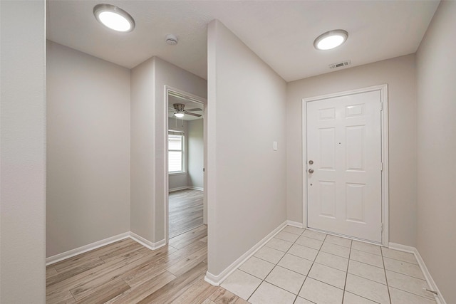 entrance foyer with light wood-type flooring, baseboards, and visible vents