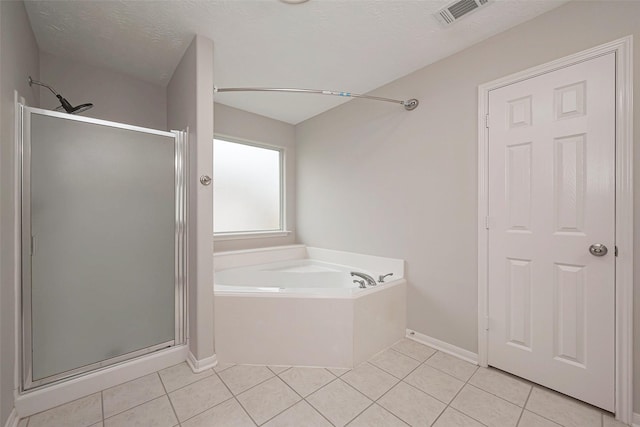 full bathroom with tile patterned floors, visible vents, a textured ceiling, a shower stall, and a bath