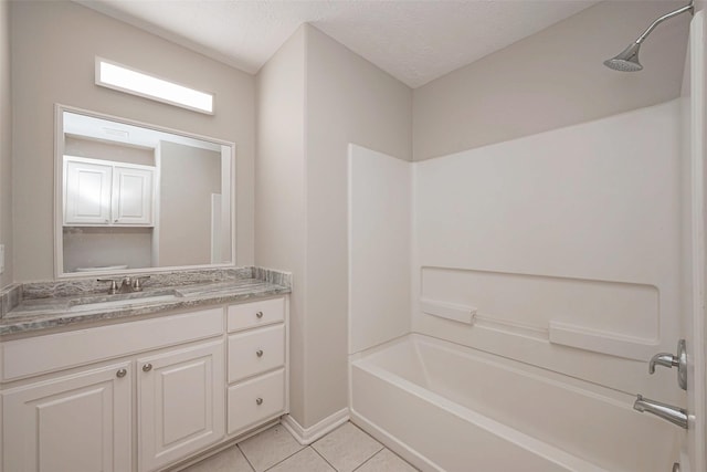 full bathroom featuring a textured ceiling, tile patterned flooring, vanity, baseboards, and washtub / shower combination