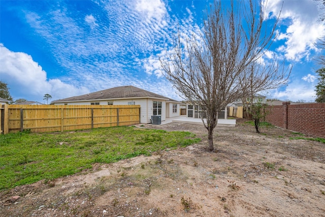 rear view of property with a patio area, a fenced backyard, and central air condition unit