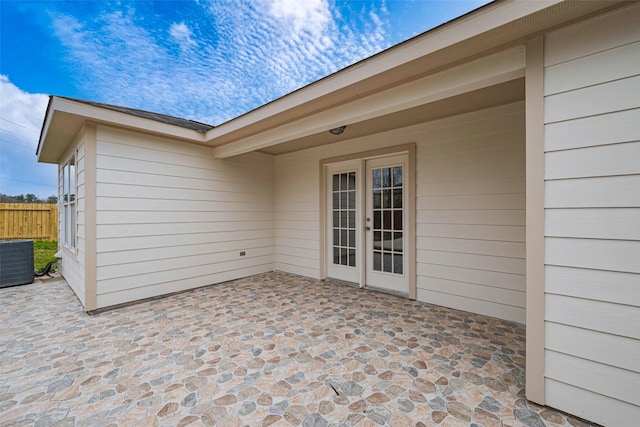 view of patio / terrace featuring central air condition unit, fence, and french doors