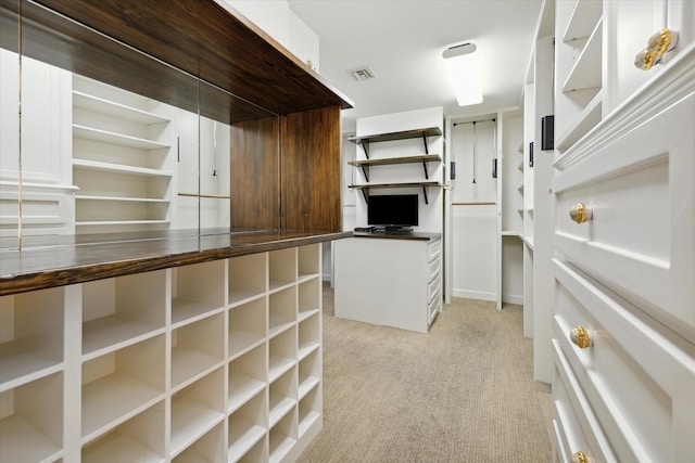 walk in closet with visible vents and light colored carpet