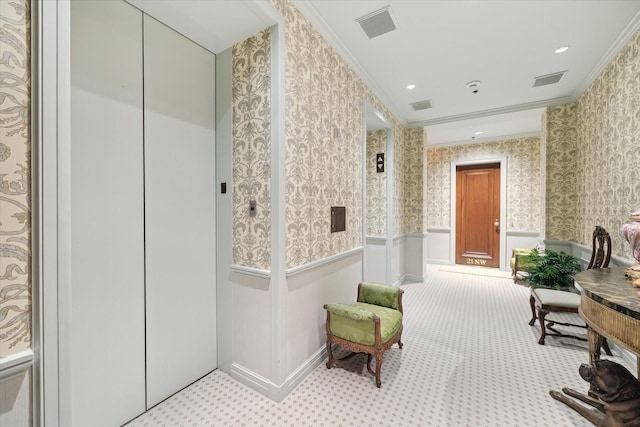 corridor featuring ornamental molding, wainscoting, elevator, and wallpapered walls